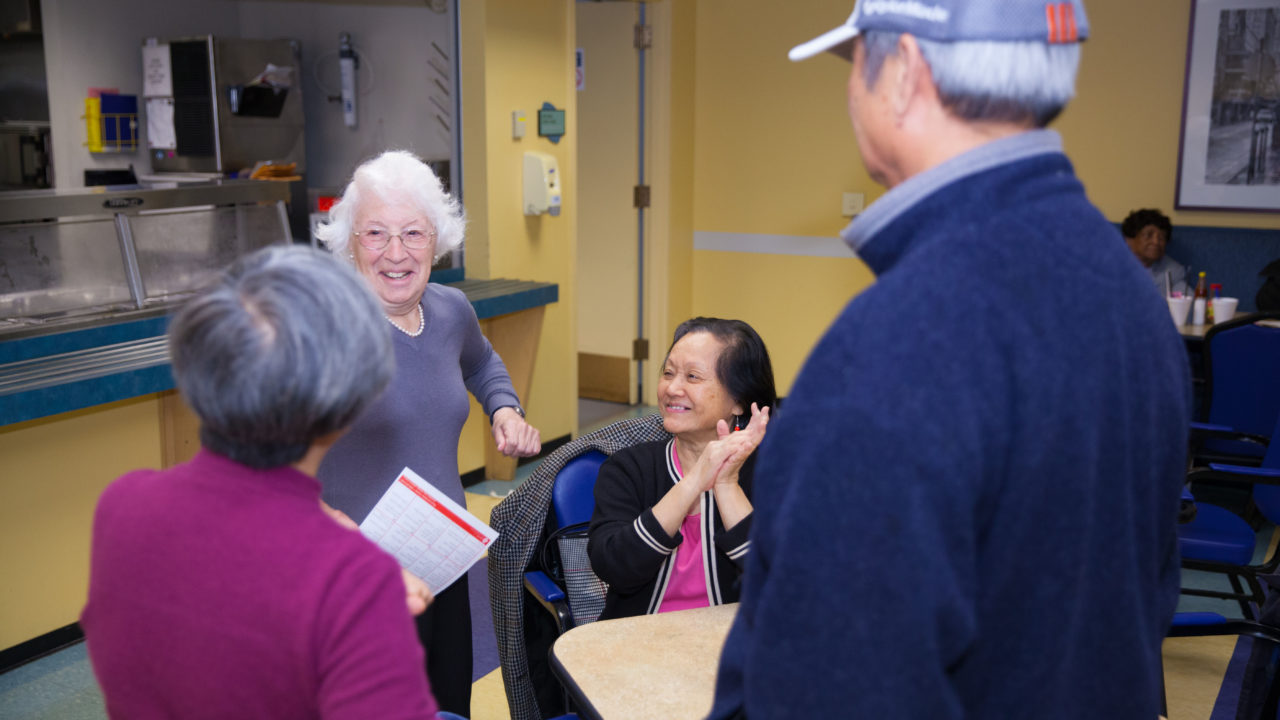 Group of men and women chatting and laughing