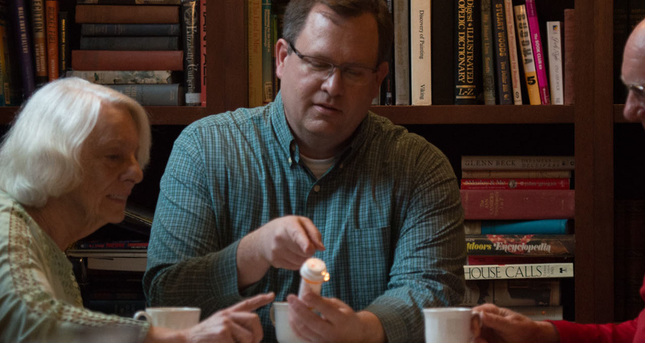 Care provider chats with older adults in library