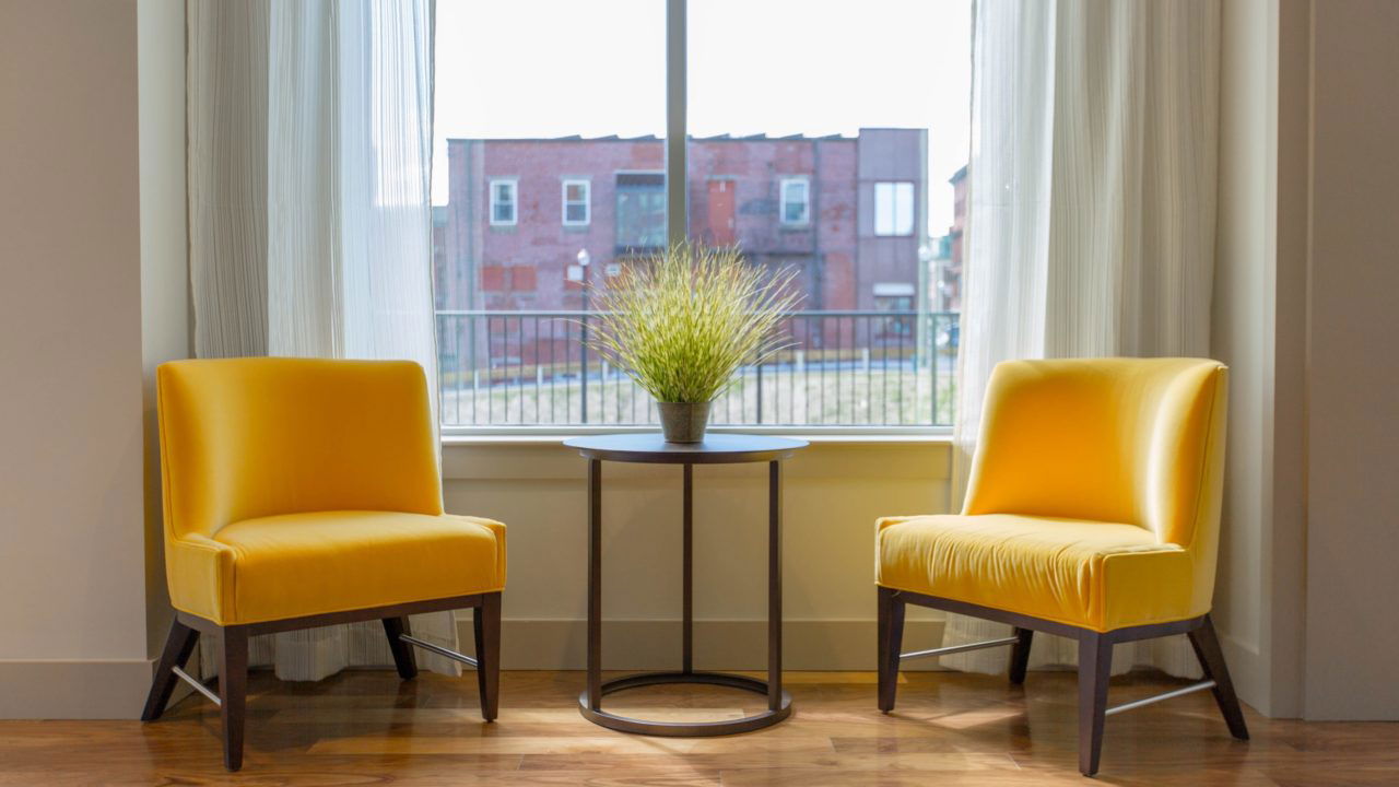 Two yellow chairs by a window