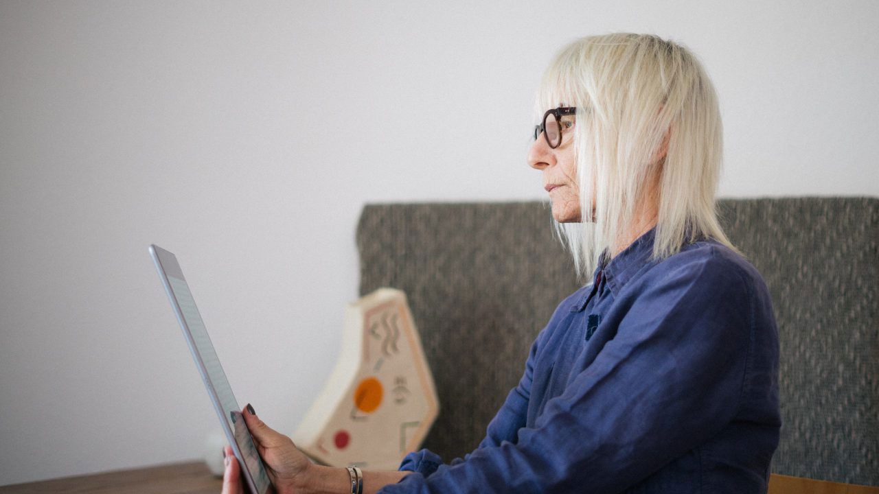 Older Woman Reading on her Tablet